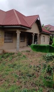 3-bedroom house with a red metal roof, unpainted plaster walls, and secure window grills.
